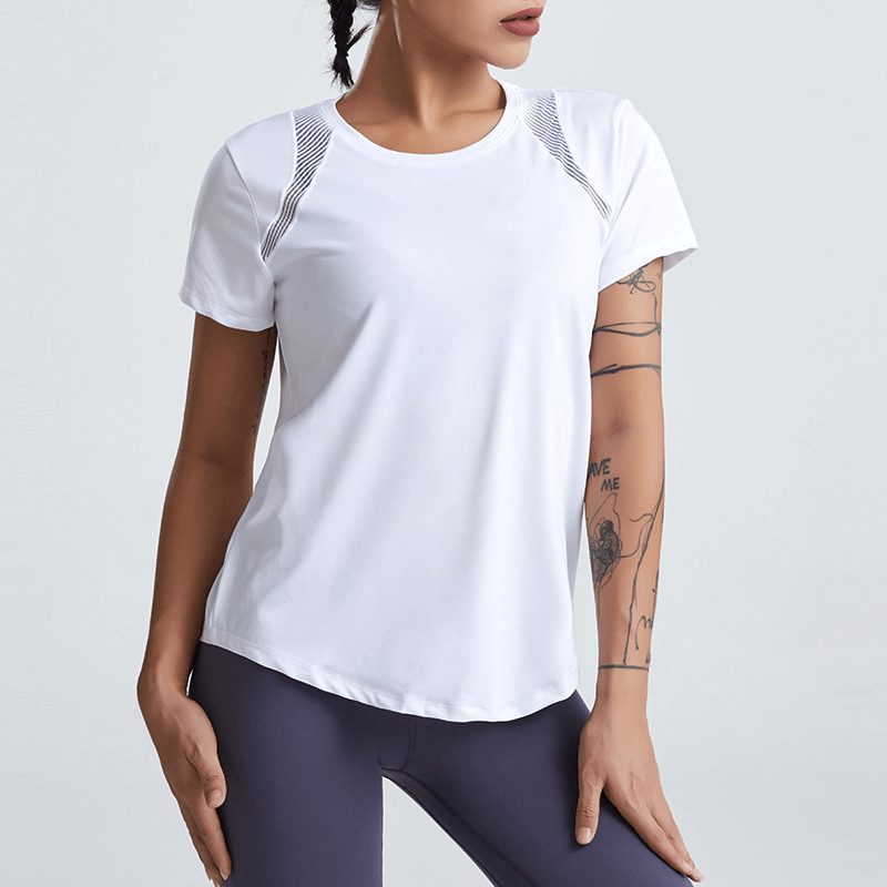 Woman wearing a white short-sleeved running t-shirt with hollow back, ideal for yoga and exercise, showcasing breathable and quick-dry fabric.